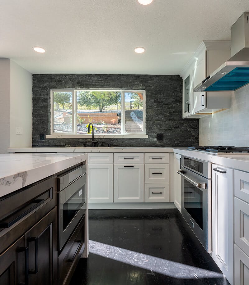 Neat kitchen with white countertops and black details